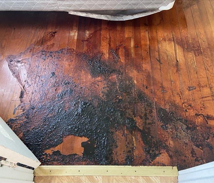 Wood flooring with blood dried on it. 