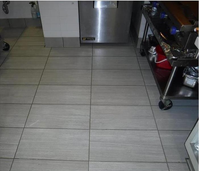Clean white tile floor of commercial kitchen