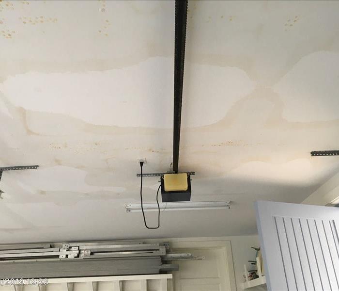 Ceiling of garage with several brown water marks. 