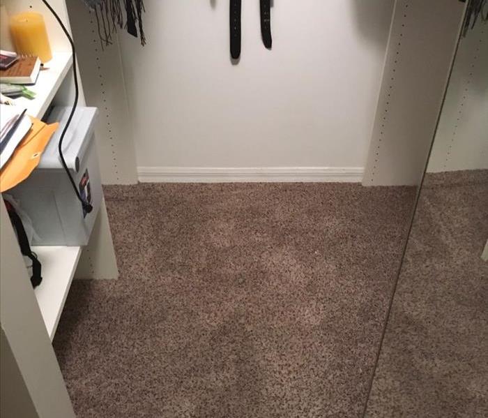 Carpet in master bedroom closet saturated with water.