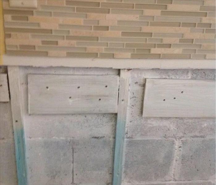 exposed cinder blocks from where dry wall was cut out to remove mold