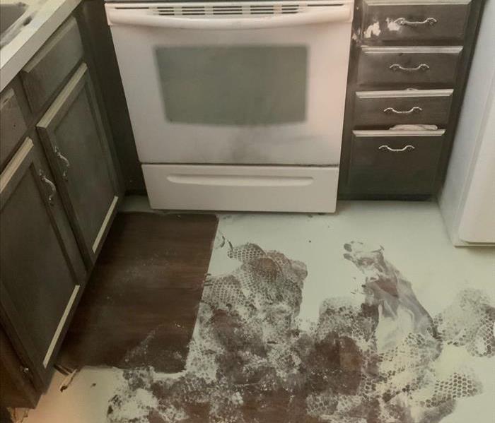 Kitchen covered in white powder from a fire extinguisher. 