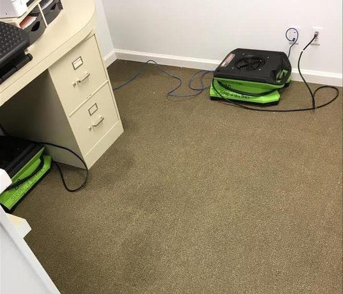 Carpet in office with drying equipment set up. 