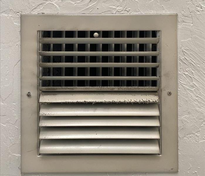 White air conditioning vent with dust build up.  