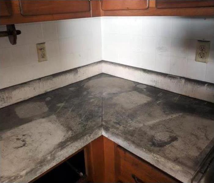 Kitchen counters covered in black soot