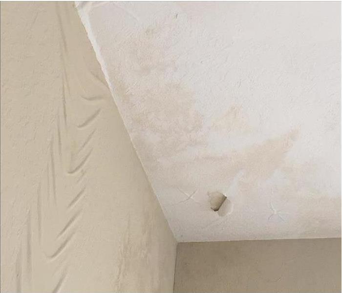 Paint on ceiling and wall damaged from water
