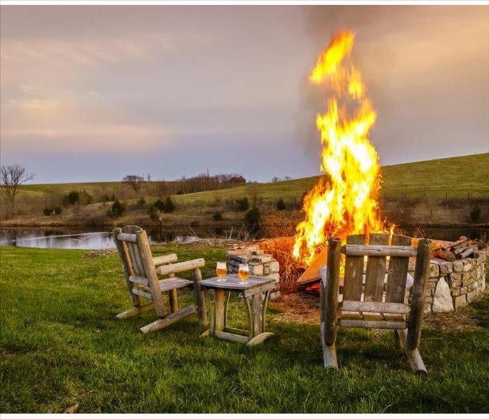fire pit in open valley with chairs surrounding