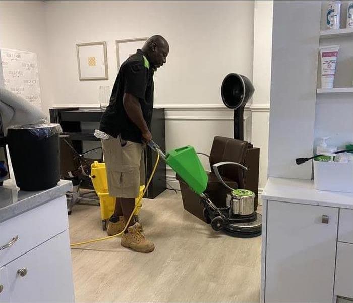 Man cleaning the floors of a salon	
