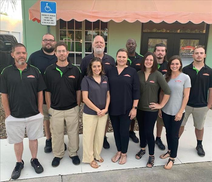 Group of employees standing outside of Servpro office for group photo. 