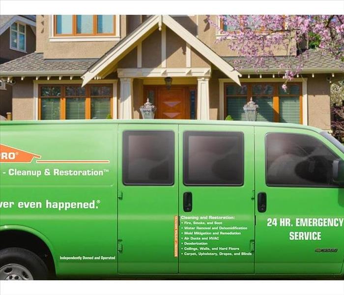 SERVPRO van parked in front of a residential home. 