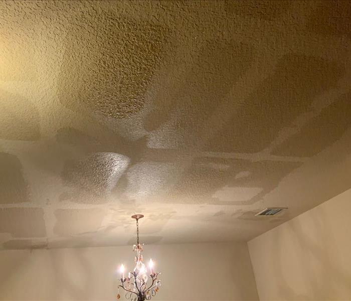 Dining room ceiling saturated with water from a leak during a storm