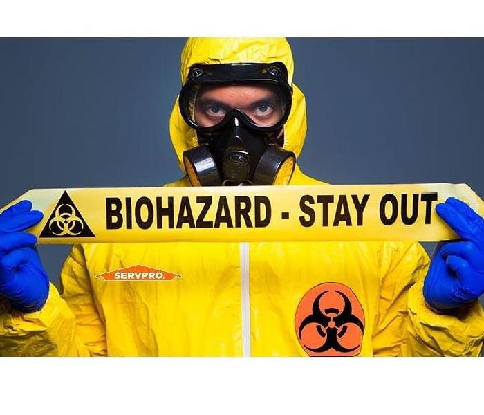 man in yellow biohazard suit with caution tape